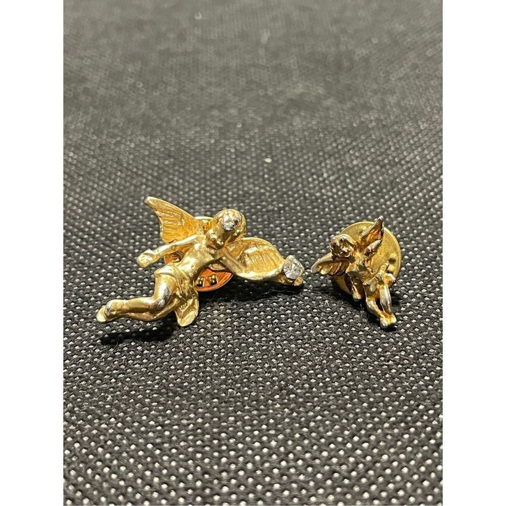 Two cherub pins